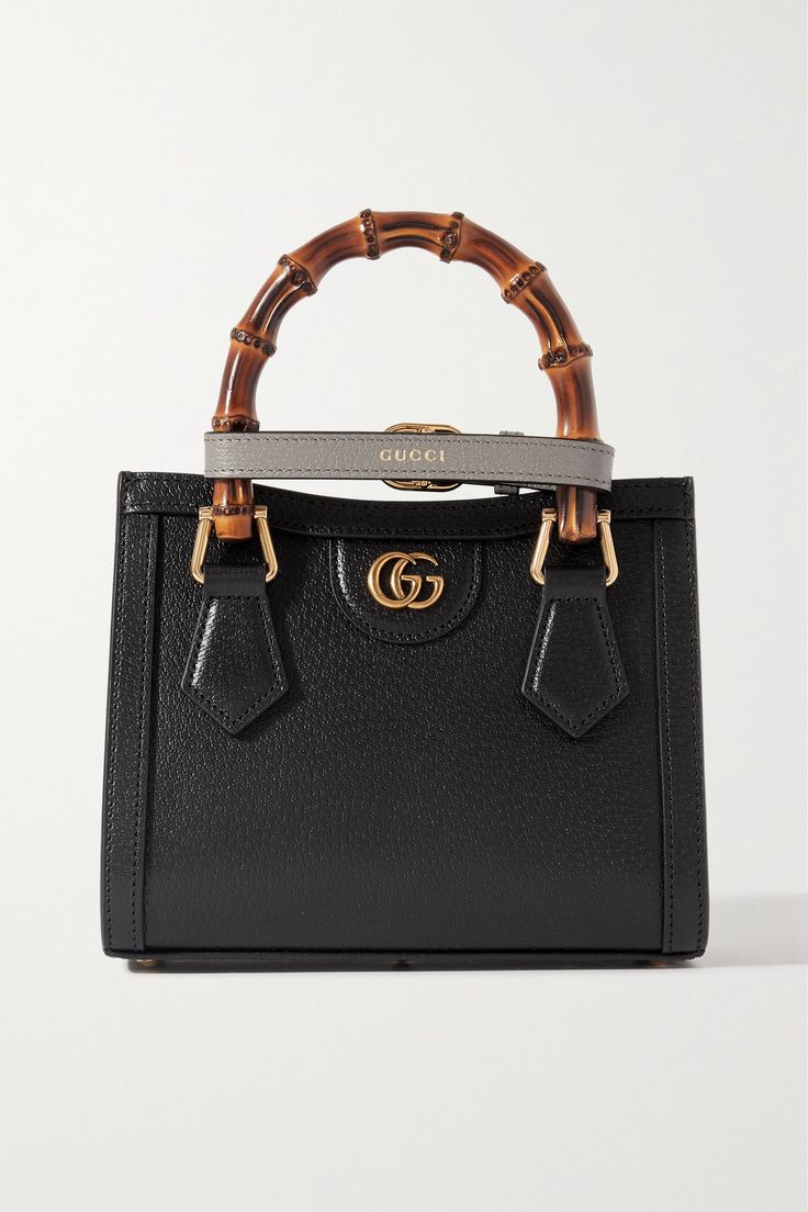 Gucci's 'Diana' tote was first introduced in 1991 and has since become an iconic style. Made from textured-leather, it's distinguished by its square shape, bamboo top handles - a house signature since 1947 - and 'Double G' gold-tone hardware. It comes with two detachable straps that can be worn on your shoulder or cross-body. Gucci Textured Leather Rectangular Shoulder Bag, Gucci Textured Leather Rectangular Bag, Gucci Rectangular Textured Leather Bag, Luxury Gucci Textured Leather Shoulder Bag, Luxury Shoulder Bag With Bamboo Handle, Designer Gucci Textured Leather Shoulder Bag, Classic Gucci Textured Leather Shoulder Bag, Designer Leather Bag With Bamboo Handle, Gucci Leather Lined Shopping Bag