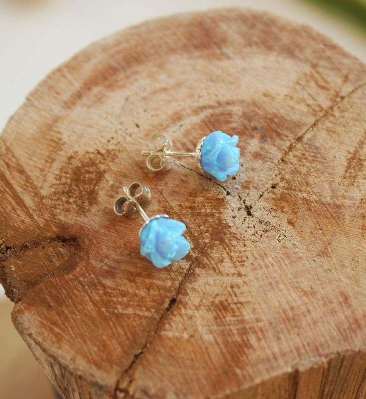 These beautiful 2 pcs of Rose flower in gentle light blue opal create a delicate yet noticeable pair of stud earrings. The opal stones are carved to a rose flower shape. They are set in a flower looking sterling silver cups so that the floral theme is complete. The earrings have two sterling silver closures. Perfect as a gift for your bridesmaids! Size of each flower: 8X8 mm Color: Light blue opal * Also available in white opal - as seen in the last photo: https://etsy.me/2GK1E68 Please note tha Blue Flower Earrings For Wedding, Dainty Blue Earrings For Wedding, Blue Flower Shaped Earrings For Wedding, Elegant Light Blue Flower Earrings For Gift, Delicate Blue Flower Earrings For Wedding, Blue Wedding Jewelry With Flower Charm, Light Blue Flower Jewelry For Wedding, Light Blue Flower Earrings Gift, Light Blue Flower Shaped Earrings For Gift