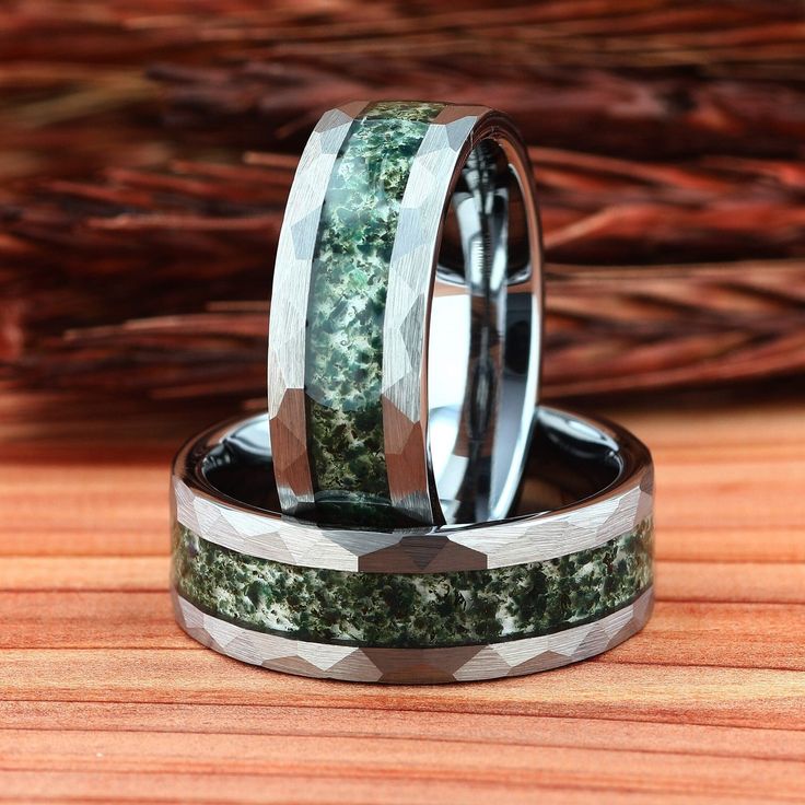 two wedding bands with green moss inlays