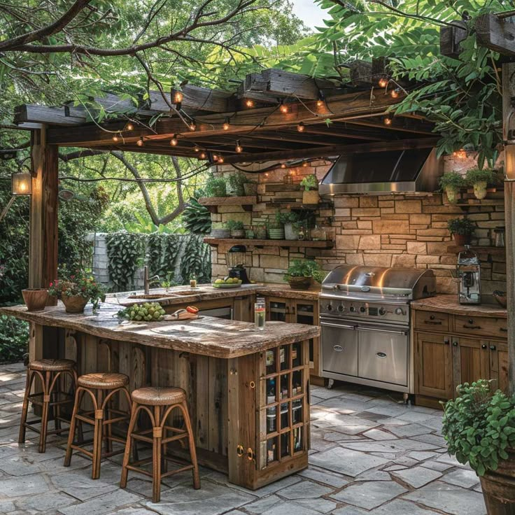 an outdoor kitchen with lots of counter space and lights hanging from the pergolated roof