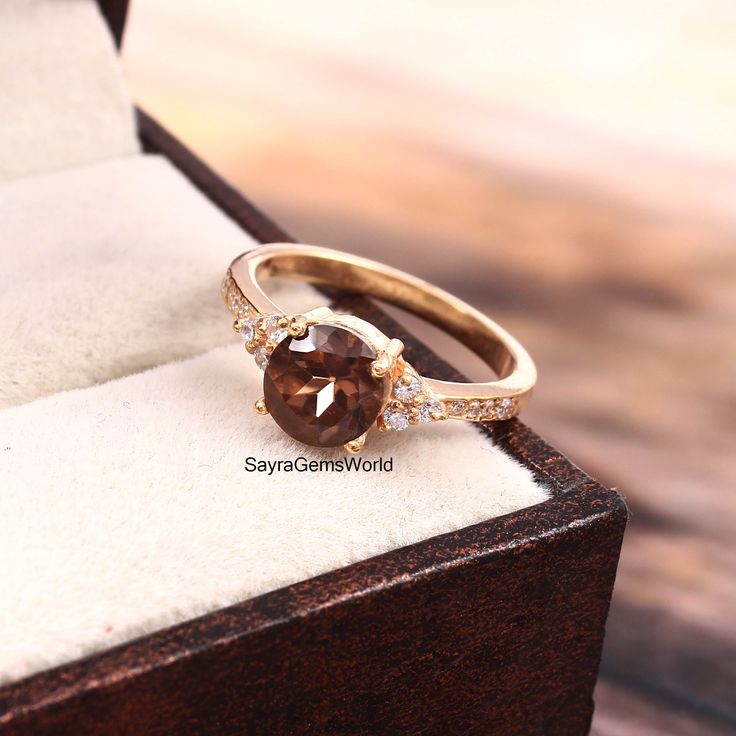 "Gemstone: Natural Smoky Quartz  This ring features a 6 MM Round cut Natural Smoky Quartz and sterling silver finished with rose gold rhodium. It is made by hand. Product Description Main stone: Natural Smoky Quartz Access Stone : Cubic Zirconia Metal type: 925 sterling silver finished with rose gold rhodium Rhodium nickel free Made In : Jaipur Rajasthan Payment Policy------------------------------ we accept payment through PayPal only, Payment should be made within 3 days of purchase. .Delivery Time------------------ Item will be Shipped Within 24 hours after payment is cleared The delivery time usually takes 11 to 23 days, depending which country & location Customers are responsible for duties and VAT charged by their country of residence. We recommend you contact your local customs offi Smokey Quartz Ring, Mothers Day Rings, Smoky Quartz Ring, Zierlicher Ring, November Birthstone, Jaipur Rajasthan, Ring Promise, Quartz Ring, Smokey Quartz