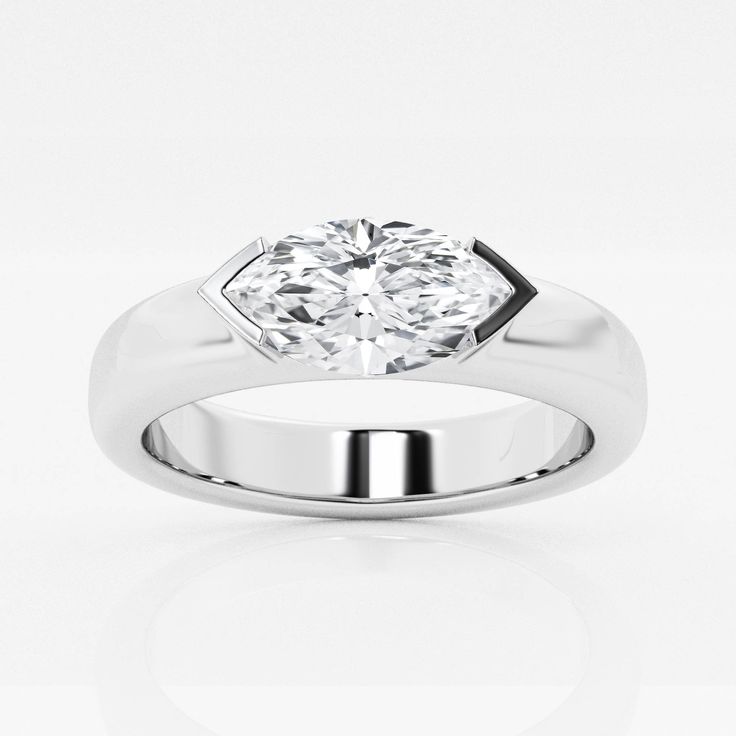 a white gold ring with a diamond in the center and an octagonal design on top