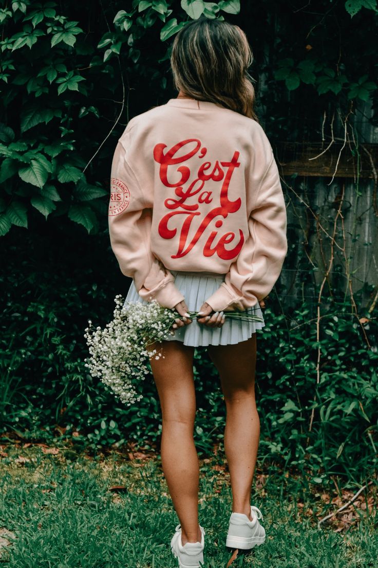 We are in our travel girl era. Take me to Paris! C'EST LA VIE!! The French saying "That's Life" is hittiing all the vibes! With the cutest little passport stamp details. This pink/peach sweatshirt with red puff print is fannnnnnntastic. Peach Sweatshirt, Take Me To Paris, Passport Stamps, Travel Girl, Puff Print, Boot Accessories, Hair Accessories Jewelry, Top Graphic Tees, Heels & Wedges