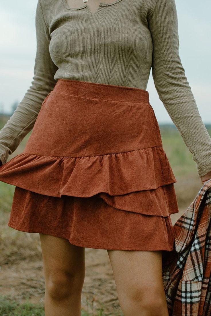 Rust Corduroy Two Tier Mini Skirt model, Brooke is 5'5" and wearing a size medium Brown Tiered Skirt Bottoms For Fall, Brown Tiered Skirt For Fall, Corduroy Mini Bottoms For Fall, Fitted Corduroy Mini Skirt For Winter, Casual Ruffled Skort For Fall, Corduroy Mini Skort For Fall, Brown Skirted Bottoms For Fall, Brown Cotton Skirt For Winter, Brown Cotton Mini Skirt For Fall