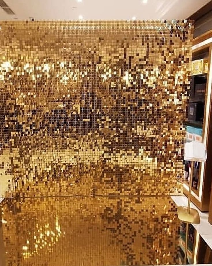 a room that has some gold tiles on the wall