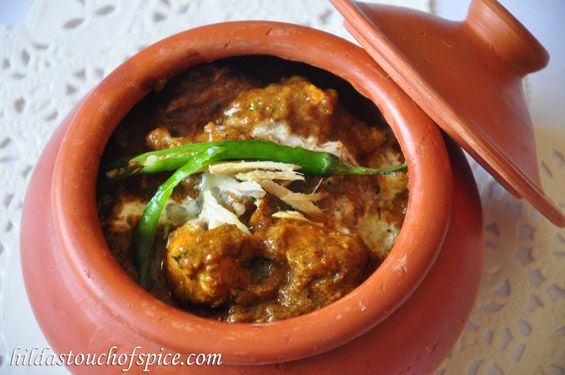 a clay pot filled with food on top of a table