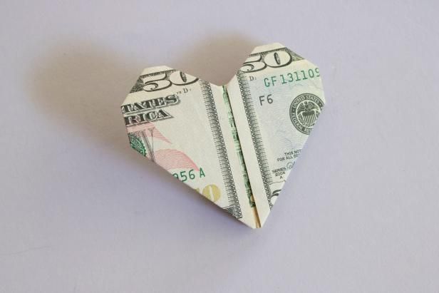 a folded up dollar bill in the shape of a heart