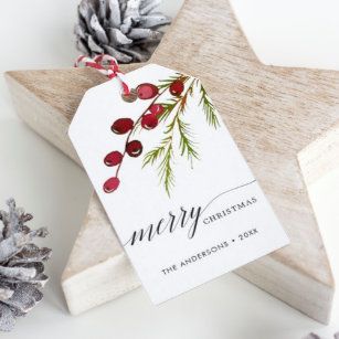 a wooden star ornament with a christmas tag on it next to pine cones