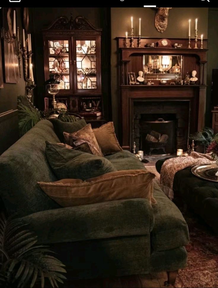 a living room filled with furniture and a fire place next to a mantle covered in candles