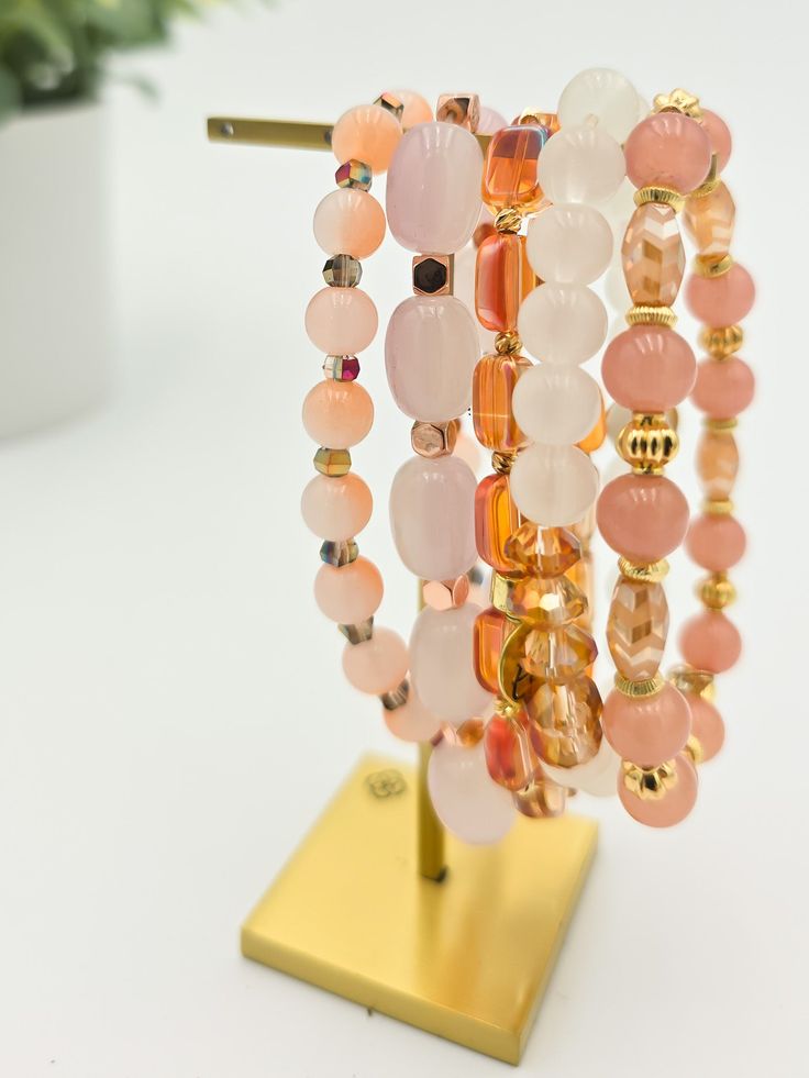 The Coco Rum Stack is a stunning and eye-catching bracelet stack that adds a subtle touch to any outfit. Its simple yet unique design will make you stand out in a playful and fun way. Lead & Nickel Free Bracelets are 'one size fits most' and are designed to fit wrists up to 7.5" comfortably. Please be aware that due to the unique and handmade nature of each product, colors, shapes, and bead sizes may vary slightly from the photos and descriptions. Trendy Stackable Wrap Bracelet With Round Beads, Trendy Stacked Bracelets As Gift, Trendy Adjustable Stackable Beaded Bracelets, Trendy Adjustable Stackable Bracelets, Trendy Stacked Adjustable Beaded Bracelets, Trendy Adjustable Stacked Beaded Bracelets, Trendy Rose Gold Bracelets With Round Beads, Adjustable Stackable Round Wrap Bracelet, Adjustable Trendy Rose Gold Beaded Bracelets