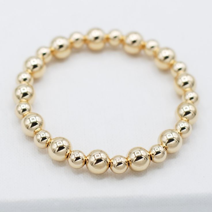 One of our classics from the beaded lux collection. Stack the alternating sized bead bracelet with a chain bracelet for a well-rounded arm party. This style is created with one of our "stretchy" cords for easy wear and effortless bracelet stacking. Bracelet is made with 6mm and 8mm alternating goldfill beads. We want to make sure your stretch bracelet has the perfect fit, so we have created sizing options to select above. Please contact us if you have any sizing questions or would like a custom Classic Gold Beaded Bracelets In 14k Gold Filled, Classic 14k Gold Filled Bracelets With Gold Beads, Elegant 14k Gold-filled Bracelets With 8mm Beads, Classic 14k Gold-filled Bracelets With Gold Beads, Elegant 14k Gold-filled 8mm Beaded Bracelets, Classic Yellow Gold Bracelet With Spacer Beads, Classic Stackable 14k Gold-filled Bracelet, Classic Hypoallergenic Beaded Bracelets, Classic Adjustable Jewelry With 8mm Beads