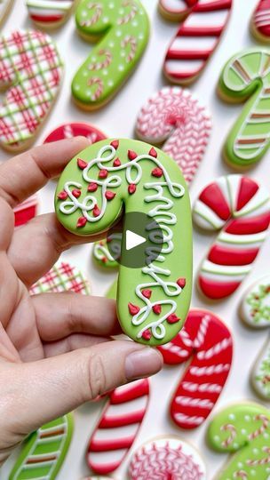 someone is holding some decorated cookies in their hand