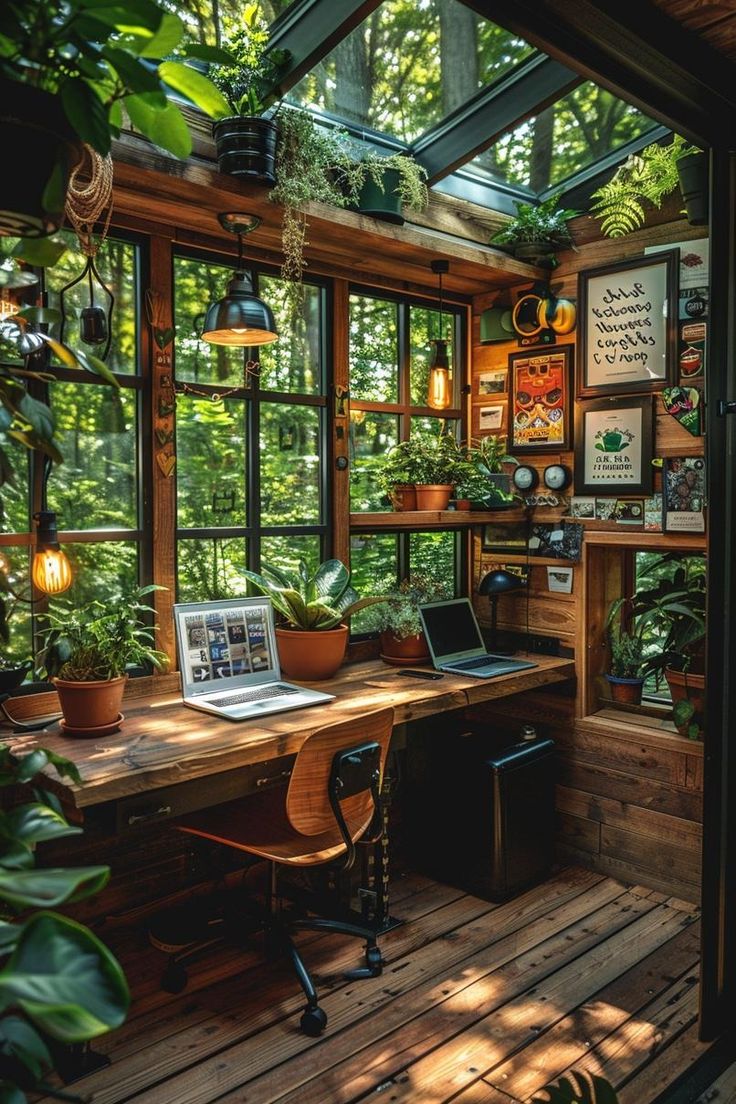 a laptop computer sitting on top of a wooden desk in a room filled with plants