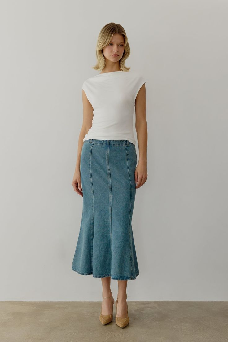 Information The Aeris Skirt is a mermaid denim midi skirt designed with a mid-rise and fit-and-flare silhouette for a flattering look. Perfect to pair with your favorite everyday tee or an elevated blouse. Details 100% Cotton Side Metal Zipper Closure Mid Waist Fit and Flare Midi Length Non Stretch Denim Kara is 5'10" and wearing a size SMeasurements: 32" Bust, 24.5" Waist, 34.5" HipsStyle #SM5130 Casual Flared Fitted Denim Skirt, Spring Flare Skirt With Stretch, Flare Skirt With Stretch For Spring, Fitted Flare Denim Skirt For Summer, Stretch Flare Skirt For Spring, Chic Flare Jeans For Summer, Chic Flare Jeans With Flared Hem For Summer, Spring Flare Fitted Skirt, Spring Flared Fitted Skirt