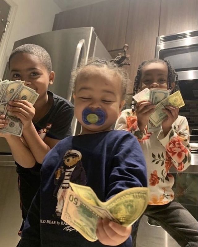 three children holding money in their hands