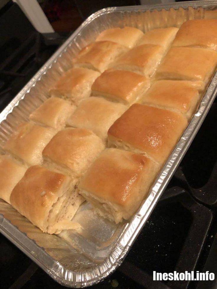 a pan filled with rolls sitting on top of a stove