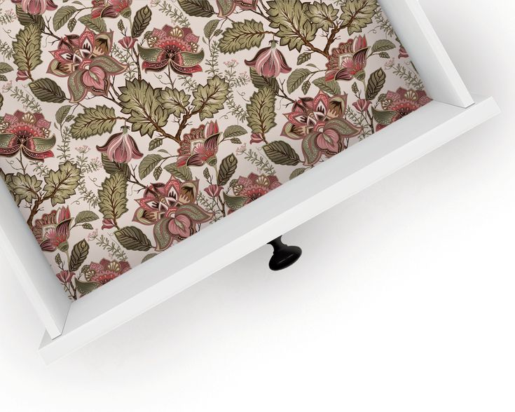 an open white box with floral wallpaper on it