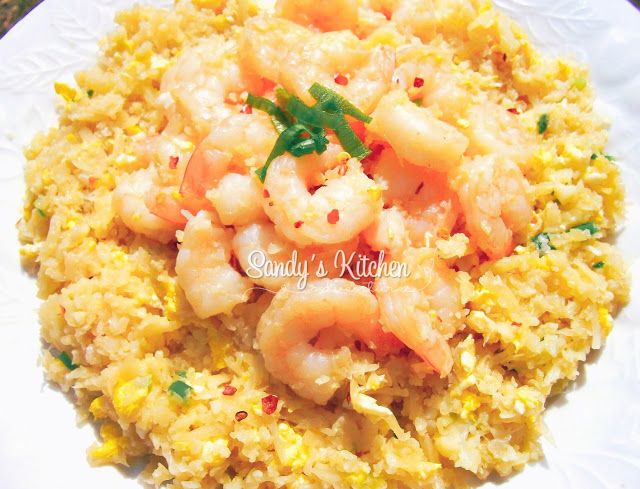 rice with shrimp and garnishes on it