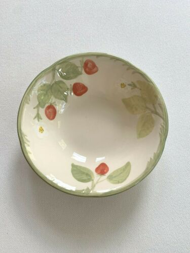 a small bowl with strawberries painted on the side and green trim around the rim