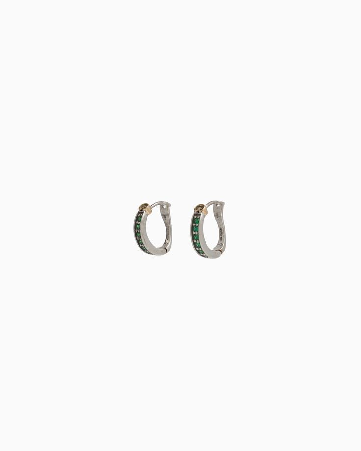 Our Stone Embellished Hoops feature a classic hoop shape decorated with green zircon stones and a signature 14K gold petroglyph. This style is perfect for everyday wear or formal occasions. Metal: Sterling silver with 14K gold accents Stone: Green zircon Dimensions: 16mm x 14mm Style #: E237GZ Elegant Green 14k Gold Huggie Earrings, Elegant Emerald Huggie Earrings For May Birthstone, Green Channel Set Jewelry For Formal Events, Formal Emerald Channel Set Jewelry, Fine Jewelry With Channel Set Green Stones, Fine Jewelry Green Channel Set, Fine Green Jewelry With Channel Set, Elegant Multi-stone Hoop Jewelry, Elegant Green Huggie Hoop Earrings