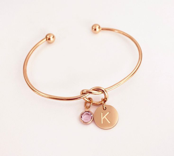 Knot Bracelet, Engraved Initial Bracelet, Birthstone Bracelet Personalized Gifts for Women, Minimalist Jewelry, Adjustable Bangle, Rose Gold Charm Bracelet (Silver and Gold Also Available). Perfect birthday gift for her, bridesmaid gifts or Christmas gift for women and teens. COMES READY FOR GIFT GIVING Rose Gold Plated, Gold Plated or Stainless Steel Knot Bracelet Includes: *Rose gold plated, gold plated or Stainless steel engraved initial charm, 12mm *Genuine Swarovski birthstone, 6mm *Note: January & July Swarovski birthstones are both Siam Adjustable knot bracelet is made with rose gold plated stainless steel, gold plated stainless steel or stainless steel. The wire size is 2mm. The bangle is adjustable to fit approximately 6 to 8 inch wrist. To adjust, it can be stretched to fit over Rose Gold Round Crystal Bracelet As Gift, Rose Gold Round Crystal Bracelet Gift, Personalized Rose Gold Bracelets For Party, Personalized Rose Gold Bracelet For Party, Adjustable Rose Gold Bangle For Gift, Adjustable Rose Gold Bangle As Gift, Adjustable Rose Gold Charm Bracelet As Gift For Her, Rose Gold Charm Bangle Bracelet As Gift, Rose Gold Crystal Bangle Bracelet Gift