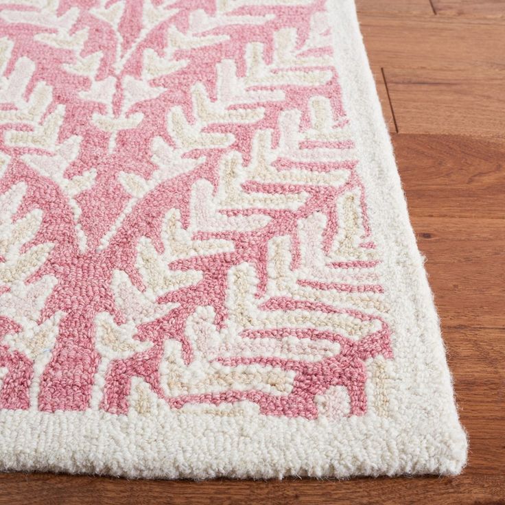 a pink and white rug on the floor