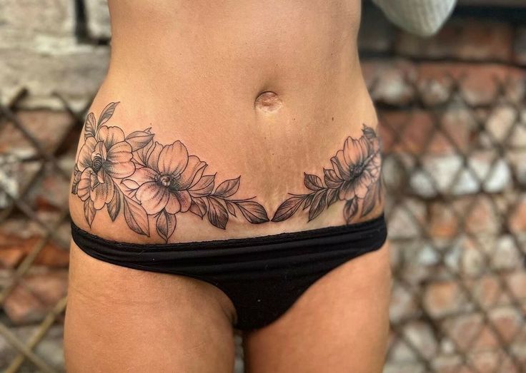 a woman's stomach with flowers on it