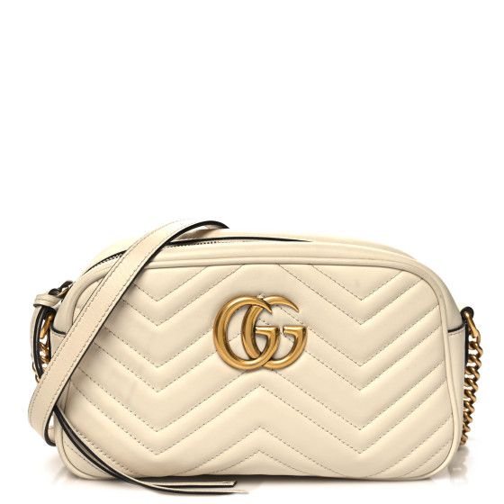 This is an authentic GUCCI Calfskin Matelasse Small GG Marmont Chain Shoulder Bag in White. This stylish shoulder bag is made of soft calfskin leather in off-white. This shoulder bag features an antiqued gold chain and leather shoulder strap, and a Gucci GG logo on the front. The top zipper opens to a beige microfiber interior with a patch pocket. Gucci Soft Leather Rectangular Shoulder Bag, Gucci Soft Leather Crossbody Bag, Classic Gucci Soft Leather Bag, Gucci Soft Leather Travel Bag, Elegant Gucci Soft Leather Bags, Gucci Luxury Soft Leather Shoulder Bag, Luxury Gucci Shoulder Bag In Soft Leather, Luxury Gucci Soft Leather Shoulder Bag, Chic Gucci Bag In Soft Leather