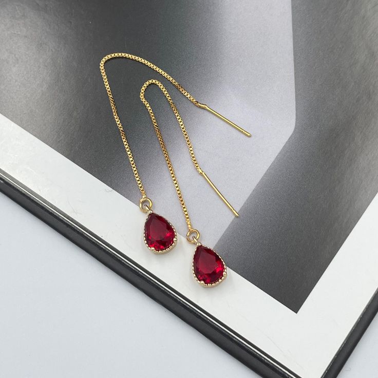 Ruby Red Thread Teardrop Earrings, Cerise Bright Red Crystal Earrings, Statement Earrings, Long Ruby Earrings, Ruby Red Thread Earrings. These are simple and beautiful ruby red teardrop crystal earrings. Bright red crystals are framed in bright gold and dangling from long thread. Measurements: The total length from the top of the hook to bottom - 3.34 inches (85 mm) approximately. Crystals: 10 mm x 6 mm The earrings would be a PERFECT GIFT for you and your family and friends! Click here to see m Red Drop Earrings For Pierced Ears, Red Teardrop Drop Earrings, Red Drop Earrings For Gift, Red Ruby Single Earring, Single Ruby Earring In Red, Red Ruby Drop Earrings, Red Long Drop Jewelry For Party, Red Teardrop Earrings For Valentine's Day, Red Teardrop Earrings For Gifts