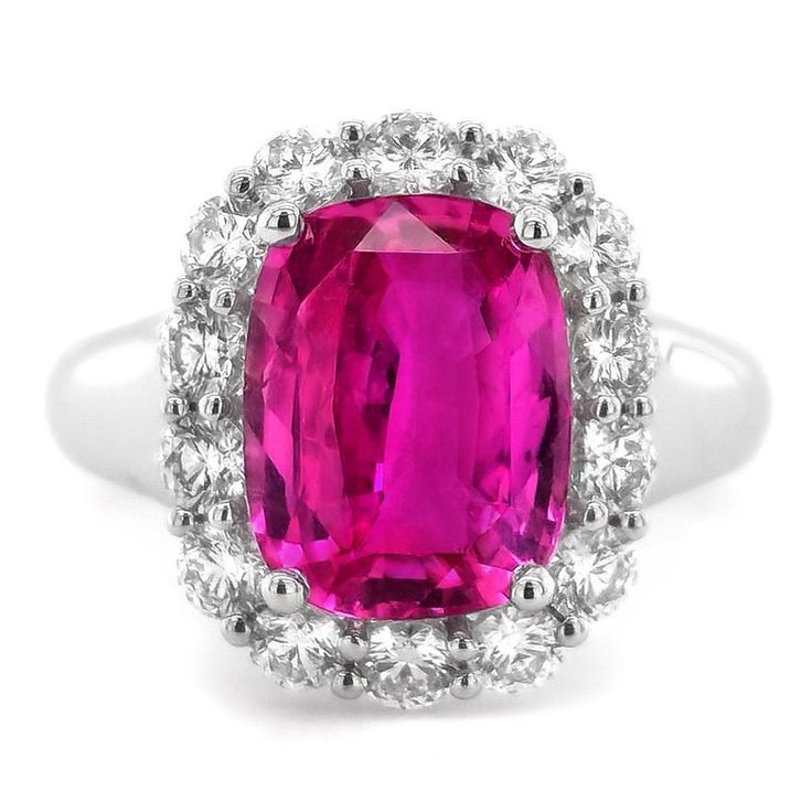 Experience the charm and sophistication of this stunning ring, featuring a vivid purplish pink sapphire from Madagascar, beautifully complemented by sparkling diamonds and set in luxurious 18K white gold.  Ring Overview: Center Stone: 4.54 carats of natural purplish pink sapphire, renowned for its vivid and enchanting color. Shape: Cushion, offering a unique and elegant profile with soft, rounded edges. Dimensions: 10.85 x 8.36 x 5.14 mm, showcasing the sapphire's substantial size and brilliance. Color: Purplish pink, with a vivid intensity that adds a vibrant touch to the ring. Clarity: Very eye clean, ensuring a flawless and radiant appearance. Cut: Brilliant/Step cut, designed to enhance the sapphire's natural sparkle and depth. Origin: Madagascar, a prestigious source known for produci Sapphire Side Stones, Pink Sapphire Ring, Diamond Ring Settings, Detailed Ring, Body Color, White Gold Ring, Fuchsia Pink, Clean Cut, Sapphire Gemstone