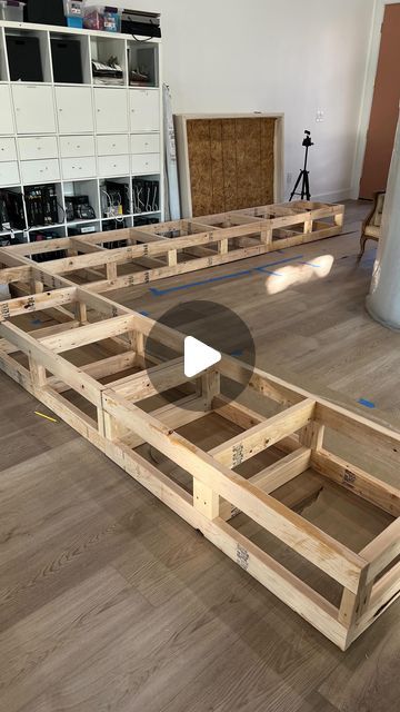 an unfinished boat sitting on top of a hard wood floor