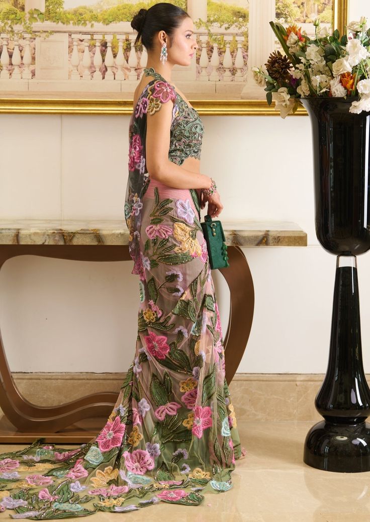 a woman standing in front of a vase with flowers on it and holding a purse