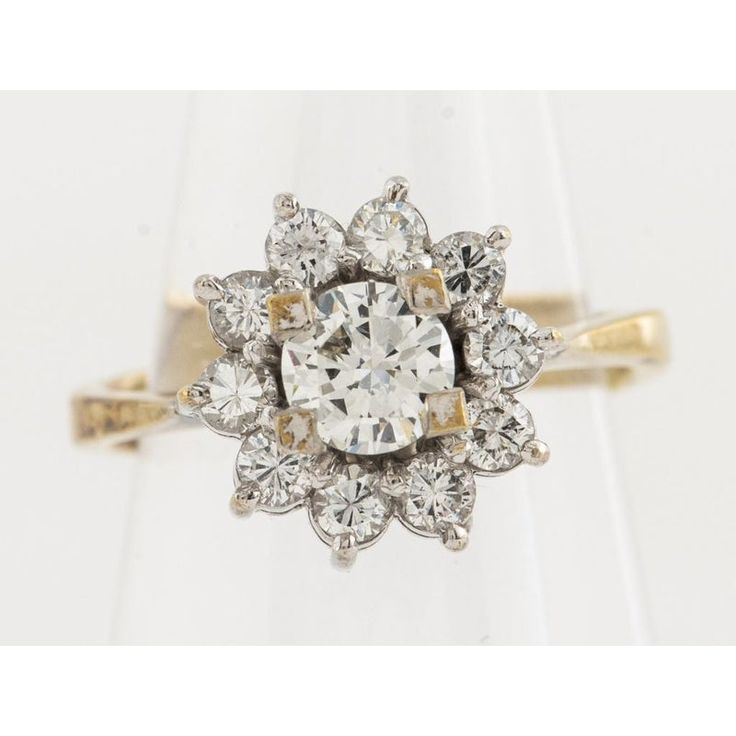 Vintage 14K yellow gold diamond cluster halo ring. Set with one round brilliant-cut diamond; approximately: 0.33 ct., color: H-I, clarity: VS2, surrounded by ten round brilliant-cut diamonds; approximately: 0.50 cttw., color: H-I, clarity: SI1-SI2.  Total weight of all diamonds: approx: 0.83 cttw.  Ring measures: 0.87"L x 0.37"W. Ring size: 1 1/2. Approximately: 1.9 dwt. inclusive. **Please note, this ring is a size 1.5 and is not one size fits all Vintage White Diamond Ring With Halo Setting, White Diamond Cluster Ring With Halo Design, White Cluster Diamond Ring With Halo Design, Diamond White Cluster Halo Ring, White Diamond Cluster Ring With Center Stone, Heirloom White Diamond Cluster Ring, White Cluster Halo Ring With Center Stone, White Diamond Cluster Ring With Rose Cut, White Cluster Ring With Center Stone