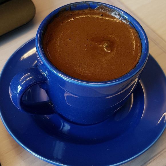 a cup of hot chocolate sits on a saucer