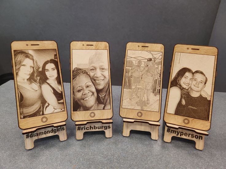 three wooden cell phones with pictures on them