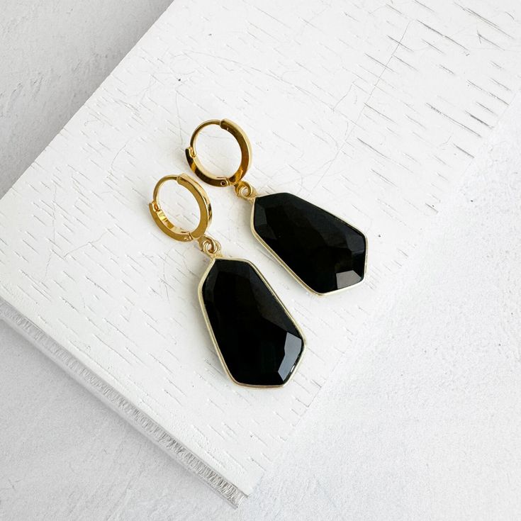 "Black Onyx Earrings | Gold Drop Earrings | Gold Plated Huggies | Simple Gemstone Earrings | Jewelry Gift for Her These elegant drop earrings feature black onyx stones. Secured with gold plated huggies, they'll provide comfort and a subtle statement. * Black onyx * Gold plated brass * Huggie * 1.5\" drop . . . . . . . . . . . . . . . .   💎 MATERIALS We use high quality chains, stones and materials. If you have any questions about stone or component colors, please don't hesitate to contact us. . . . . . . . . . . . . . . . . . . . . . . . . . . . . . . . . .  📦 PRODUCTION & SHIPPING All pieces are made by Tracy in her studio in sunny Northern California, so please allow 2-3 days before your order is ready to be shipped. Keep in mind that production time does not include shipping time.  Sh Black Faceted Earrings As A Gift, Faceted Black Earrings Gift, Black Onyx Earrings, Drop Earrings Gold, Black Onyx Stone, Onyx Earrings, Onyx Stone, Gold Drop Earrings, Northern California