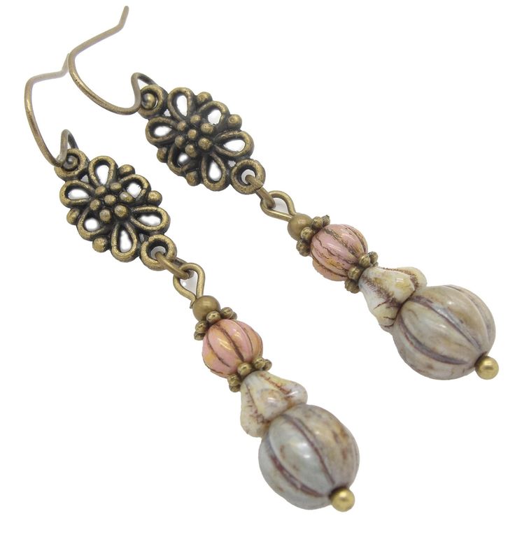 "These are long rustic boho earrings, handmade with aged looking pink, cream and green blue beads that have a lovely marbled finish.  I added a pretty brass charm to finish these comfortable earrings off. They are light earrings with ancient looking Czech glass beads that have an olde world feel. These neo victorian earrings are hung on quality solid brass french hook earwires. Brass is nickel free.  Length: About 2\" (5.1 cm) long See more of my jewelry here: http://www.etsy.com/shop/CloudCapJe Dyi Earrings, Czech Beads Jewelry, Victorian Style Jewelry, Victorian Earrings, Neo Victorian, Light Earrings, Rustic Boho, Fall Jewelry, Dangly Earrings