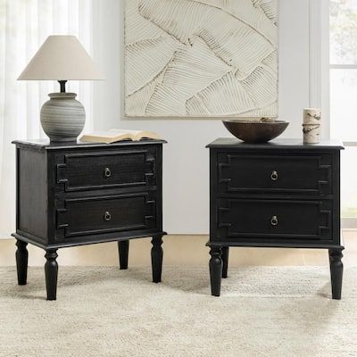 two black nightstands sitting on top of a white rug