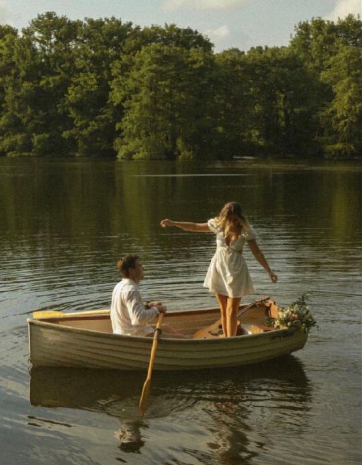 two people in a small boat on the water