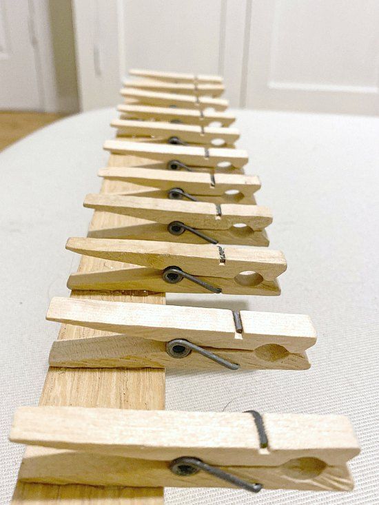 a row of wooden clothes pins sitting on top of a table