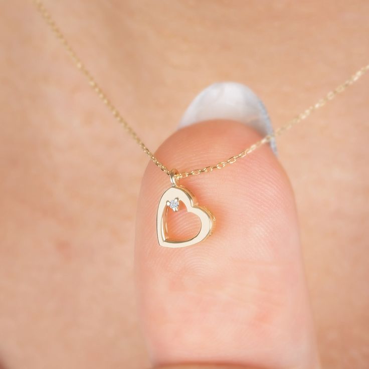 "Diamond Dangle Heart Necklace in 14k Solid Gold, Real Diamond Open Heart Necklace, Minimalist Heart Necklace, Heart Talisman, Valentine Gift F E A T U R E S * Made to Order. * Gold KT: 14K * Choice of Gold Color: Yellow Gold, Rose Gold, White Gold * Gem Stone: Genuine Diamond * Diamond-Cut: Round * Diamond Carat: 0.01 ct. * Pendant Height: 9,50 mm / 0.37 inch * Pendant Width: 7,50 mm / 0.30 inch * Diamond Color-Clarity: G.VS Color, SI Clarity * Length: 14\", 16\", 18\", 20\", 22\", 24\" * Setting Type: Bezel Setting * Ready to Ship in 1-3 Business Days * 100% US sourced * 2 Years Warranty * Free Express International Shipping * Free returns within 14 days from the order date We loved making our jewelry with special designs for your special moments. Wishing you to share the joy on a perfec Gold Heart Necklace With Diamonds, 14k Gold Heart Pendant Charm Necklace, 14k Gold Heart Cut Diamond Jewelry, 14k Gold Pendant Charm Necklace For Valentine's Day, 14k Gold Heart Charm Necklace, Yellow Gold Heart-shaped Birthstone Jewelry, Delicate 14k Yellow Gold Heart Necklace, 14k Gold Heart Pendant Necklace, Fine Jewelry 14k Gold Heart Pendant Necklace