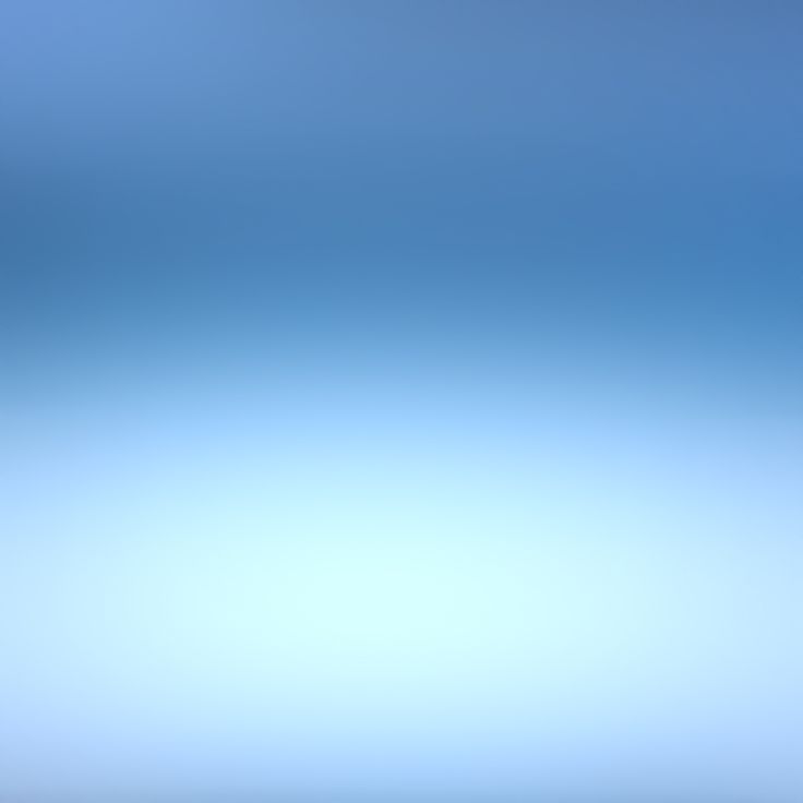 blurry image of blue sky with white clouds in the foreground and water below