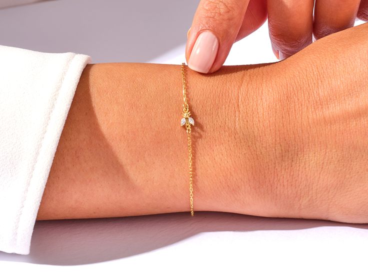 A luxurious addition to any ensemble, this Diamond Bee Bracelet in 14k Gold exudes glamour and sophistication. Featuring a 14k Gold setting and a shimmering Diamond Bee charm, this is the perfect piece for those with a taste for high-end fashion. Features• Made to Order• Gold Kt: 14K• Gold Color: Rose Gold, Yellow Gold, White Gold• Gem Stone: Natural White Diamonds• Diamond Cut: Marquise• Number of Stones: 2• Available Stone Sizes: 2 x 1.50 x 3.00 mm• Total CTW: 0.05 ct• Diamond Color - Clarity: Dainty Rose Gold Bracelet With Brilliant Cut, Elegant Diamond Gold Bracelet As Gift, Elegant Gold Diamond Bracelet As Gift, Elegant Gold Diamond Bracelet For Gift, Elegant Gold Diamond Bracelet Gift, Handmade 14k Rose Gold Bracelet, 14k Rose Gold Bracelet Hand Set, Elegant Gold Bracelet With Diamond Accents As Gift, 14k Rose Gold Hand Set Bracelet