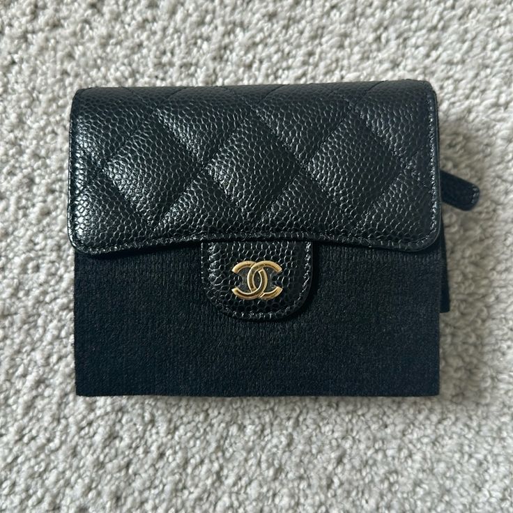 Brand New Chanel Tri Fold Wallet Plastic And Encasing Still Intact Includes Box, Case, Receipt, Authentication Cards / Full Set No Flaws/No Wear/Never Used Dimensions: 4.5"W X 4"H X 1"D Comes From A Smoke/Pet Free Environment. No Trades. Please Ask All Questions Before Purchasing. Thanks. Designer Compact Coin Purse For Travel, Luxury Bifold Coin Purse For Travel, Luxury Compact Wallets For Daily Use, Luxury Black Wallets For Daily Use, Luxury Black Wallet With Coin Pocket, Luxury Black Wallets With Coin Pocket, Luxury Compact Wallets For Everyday Use, Designer Black Compact Coin Purse, Black Rectangular Coin Purse With Coin Pocket