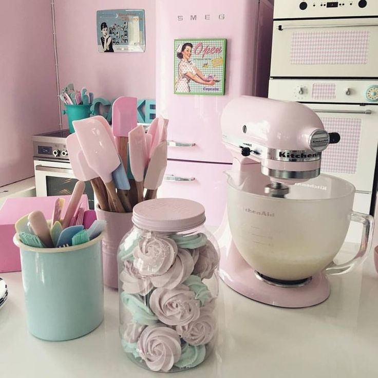 a kitchen counter with pink appliances and utensils