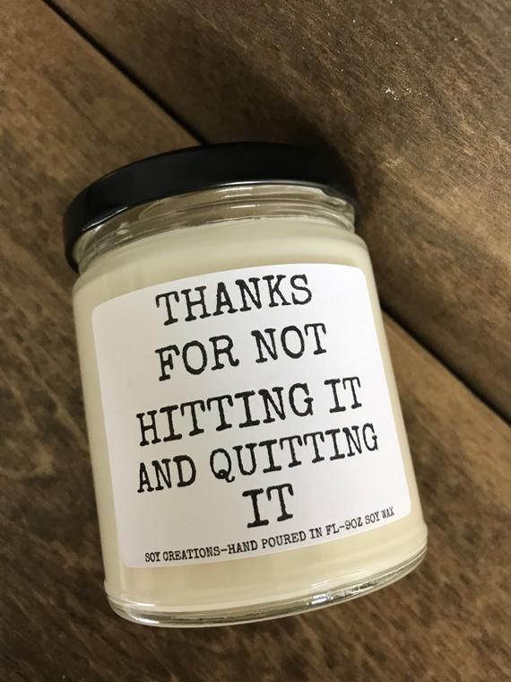 a jar of white candles sitting on top of a wooden table with the words thanks for not hitting it and quiting it