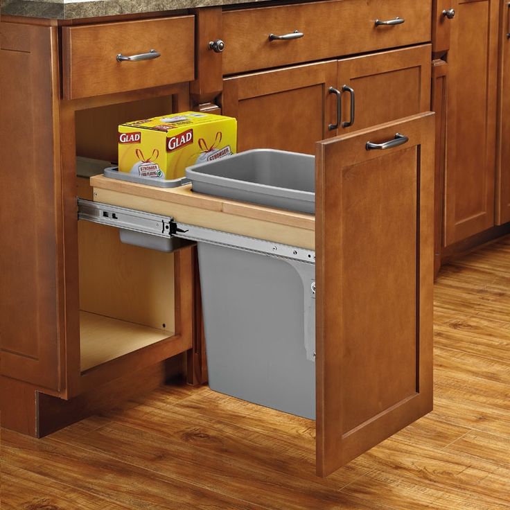 a kitchen with wooden floors and cabinets has an open dishwasher in the middle