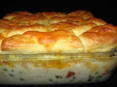 a casserole dish with meat and cheese in the center, on a black surface