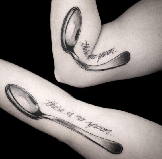 two tattoos with spoons and words on their arms that say, there is no spoon