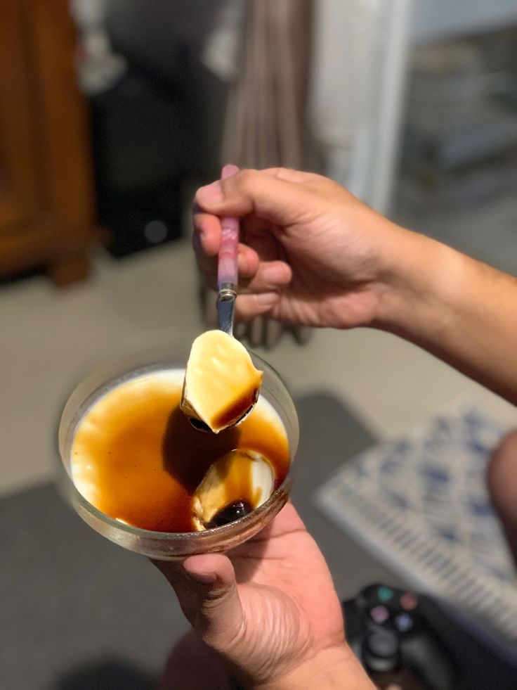 a person holding a glass filled with liquid